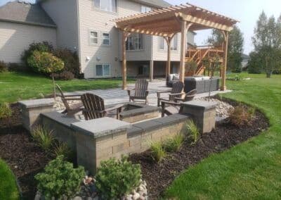 Backyard patio featuring a pergola, seating area, and lush landscaping. Perfect for outdoor gatherings.